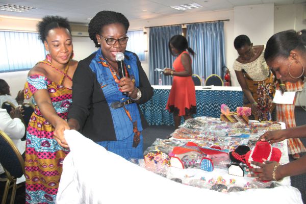 Nana Oye Lithur (2nd left), and Ms Ethel Amekortu (left), jointly performing the  launching ceremony 