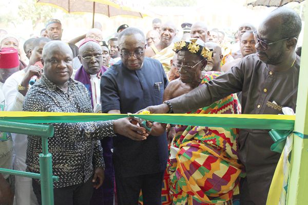 The new DVLA office building at Wenchi. INSET: Mr Kwasi Agyeman Busia (2nd left), assisting the acting President of the Wenchi Traditional Area, Nana Asimpi Tabiri Adinkra Kosopre III (2nd right), to inaugurate the building. Also in the picture is the Board Chairman of the DVLA, Mr Frank Davis (right)