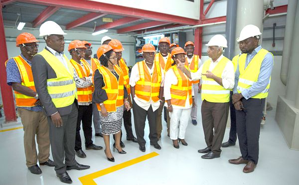 Mr Anil Kansara (right) briefing the Board Members during the tour of the refinery. Also in the picture in Mr Sampson Nortey (left), MD of Gold Coast Refinery