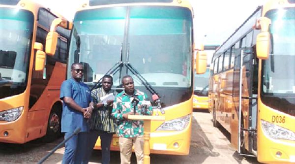Mr Ahmed Arthur speaking at the ceremony after handling over the keys to the buses to Mr Albert Adu Boahen (left).