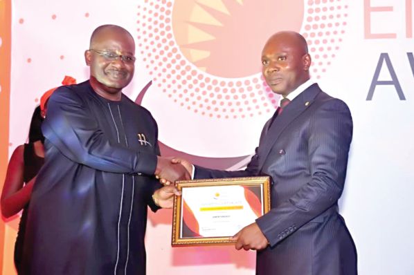 Mr Kwame Jantuah, an energy consultant (left), presenting Ameri’s award to Mr Francis Kpollu (right), the Country Manager of Ameri Energy