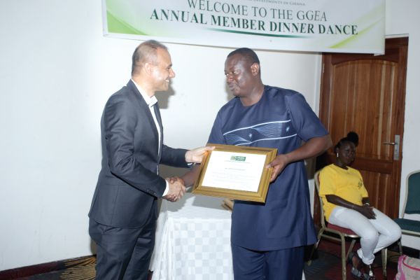 An official of the German Embassy (left), presenting an award to Mr Samuel Doe Ablordepey (right), a Sub Editor of the Daily Graphic at the Ghanaian German Economic Association (GGEA) award and dinner event  in Accra