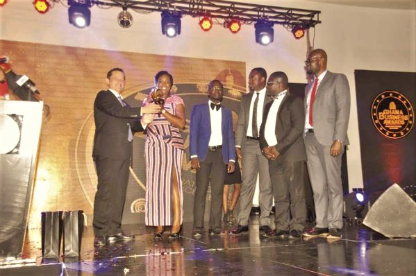  Dr Lamisi Mbillah (2nd left), Customer Relations Manager at G4S, receiving the Security Company of the Year trophy on behalf of her company at the Ghana Business Awards. Behind her are other G4S officials