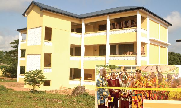  Odeefuo Amoakwa Buadu VIII (right), cutting the tape to inaugurate the classroom block (main picture). Looking on are Mr Eric Owusu-Appiah, PTA Chairman (left) and other guests.