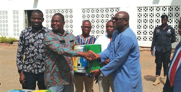 Alhaji Sulemana Alhassan (right) in a handshake with Mr Abudulai Antiku during the presentation ceremony