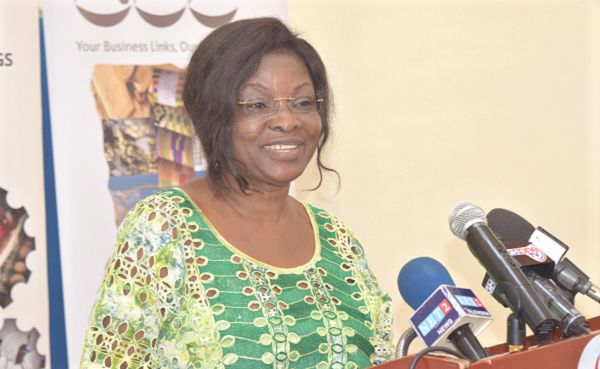 Ms Gifty Ohene Konadu, (inset) National Coordinator of the One district One factory Secretariat speaking at the event. Picture: GABRIEL AHIABOR