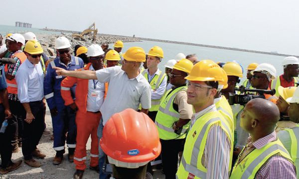 Mr David Benayum of Amandi Holdings (hand stretched) breifing Mr Amewu (third left) on the project