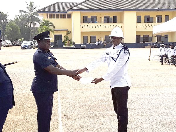 DCOP Mr Kwasi Mensah Duku (left), Ashanti Regional Police Commander presenting a certificate to a participant