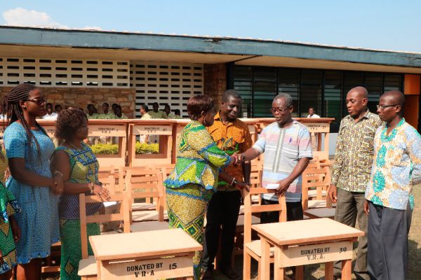  Mrs Gertrude Koomson (left) presenting the furniture to Mr Enerst Bediako Asare