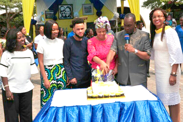    Rev. Samuel Adjepong (with microphone), and his wife, Mrs Florence Adjepong, the Founders of the Alpha Beta Education Centre, were joined by some family members to cut the 30th anniversary cake.