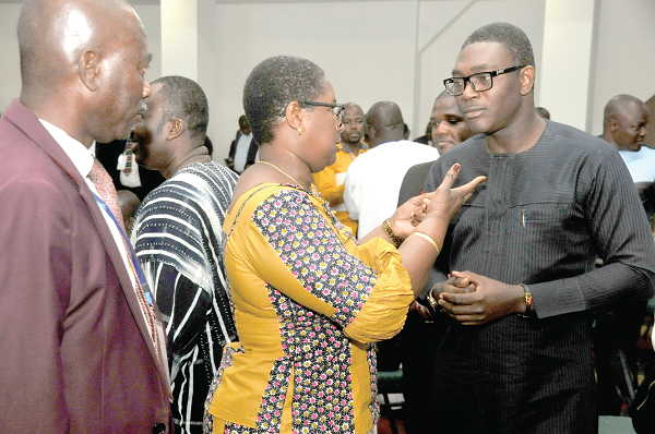 Mrs Mami Dufie Ofori (middle) the Executive Secretary, PURC, explaining a point to some participants.