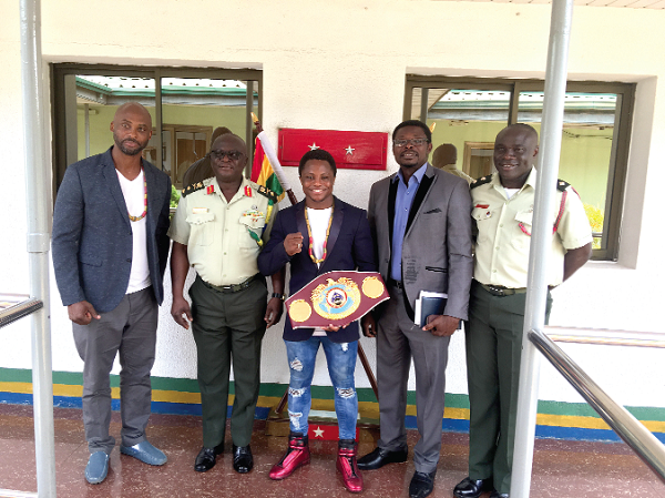  Maj. Gen. William Ayamdo (2nd left) with Isaac Dogboe (middle) after the meeting. With them is Paul Dogboe (left) and other officials