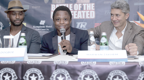  Isaac Dogboe (middle) addressing yesterday’s press briefing as his father Paul Dogboe (left) and the boxer’s manager, Marwan Zakhem look on.