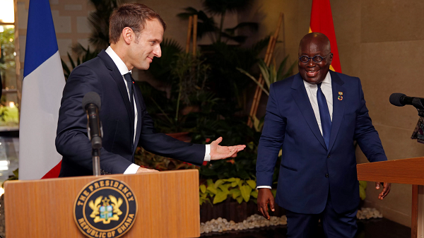 French President Emmanuel Macron speaks with Ghana's President Nana Akufo-Addo in Accra