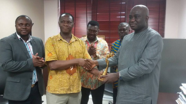 Prof Victor Yankah (2nd left) presenting the award to Mr Eric Opoku,  MP for Asunafo South