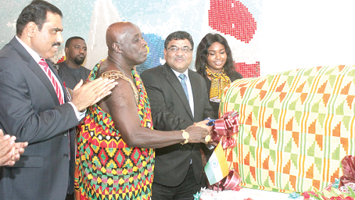 Osagyefuo Amoatia Ofori Panin II (2nd left), Okyenhene, and Mr Birender Singh Yadav (right), cutting a tape to unveil the new 'LAY MORE' poultry feed. With them include Mr Lalit Mishra (left). (INSET): The poultry feed that was unveiled. Picture: BENEDICT OBUOBI