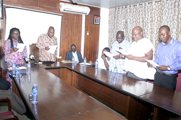  Ms Elizabeth Afoley Quaye (left),  swearing in the Greater Accra Regional premix committee members.