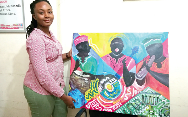 Chetan Melche Gbedemah displays one of her paintings.