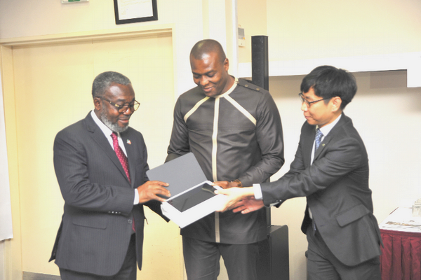 Mr Kelvin Ntiamoah Sarpong (middle), the Head of Mobile Division of Samsung Electronics Ghana,  presenting one of the laptops to Dr Anthony Nsiah-Asare, the Director-General of Ghana Health Service. With them is Mr Ilwon SEO, Managing Director, Good Neigbours Ghana. 