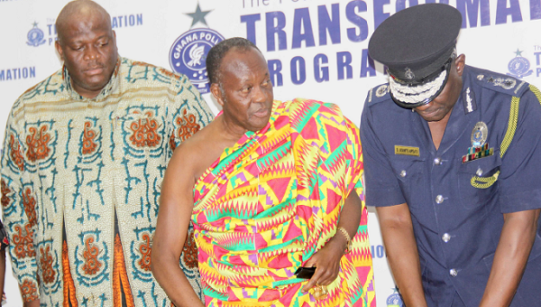 Nana Otuo Siriboe (2nd left), the Chairman of the Council of State, explaining a point to Mr David Asante-Apeatu (right), the Inspector General of Police  after the launch. Looking on is Mr Henry Quartey (left), Deputy Minister of Interior. Picture: EDNA ADU-SERWAA