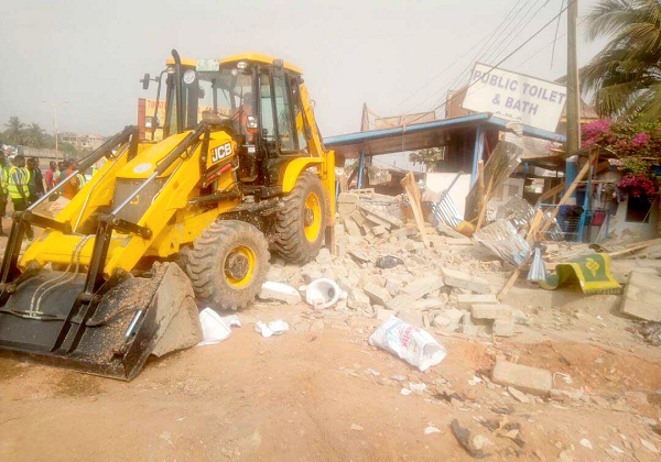  A bulldozer raes the toilet to the ground