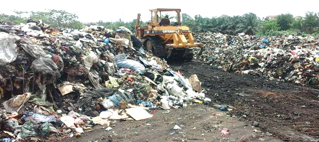 A bulldozer clearing refuse at the Presby transfer site