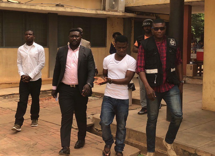 Daniel Asiedu (2nd right) and Vincent Bosso (left), being escorted from the court premises.