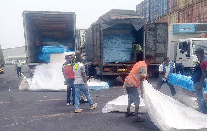Smuggled used matresses being packed into waiting trucks 
