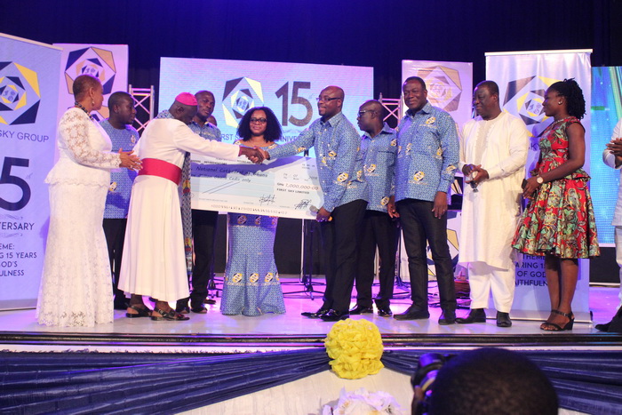 Mr Eric Seddy Kutortse (4th right), Chairman and CEO of First Sky Group presenting a dummy cheque to Most Rev. Dr Samuel Asante Antwi, the Chairman of the National Cathedral trustee. With them are Mr Kofi Dzamesi (3rd right), the Minister of Chieftaincy and Religious Affairs, Mr Kwasi Amoako Attah (2nd right),  the Minister of Roads and Highways and some staff of First Sky Group