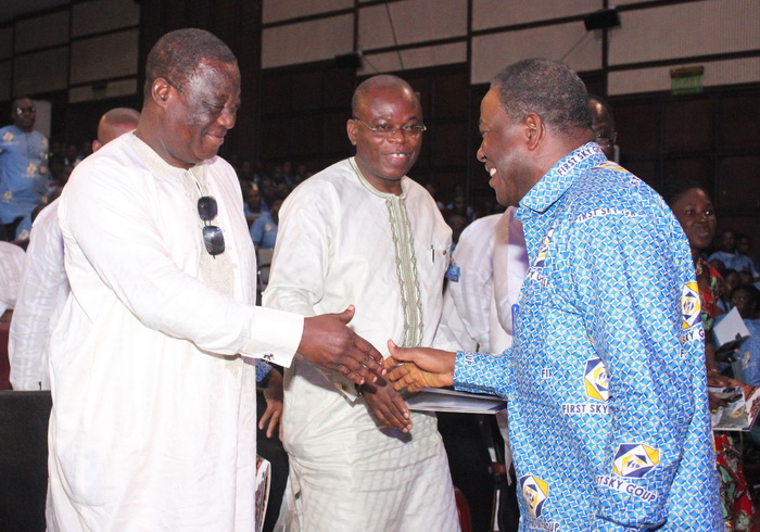 Mr Kofi Dzamesi (right), the Minister of Chieftaincy and Religious Affairs, being congratulated by Mr Amoako Attah (left), the Minister of Roads and Highway and Mr James Avedzi.