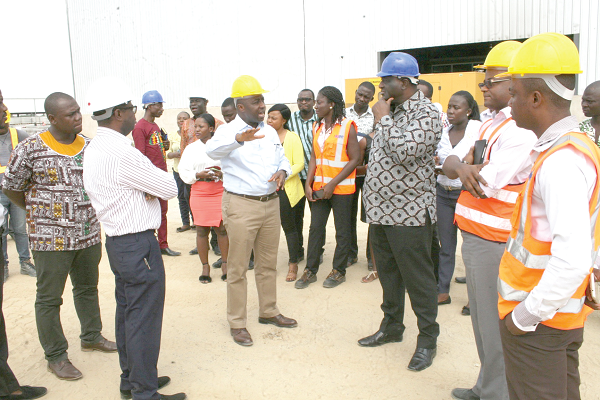 Mr Ernest Owusu Afari (left), Director, Power Business, LMI explaining a point to Mr Alan Kyerematen (right), the Minister of Trade and Industry