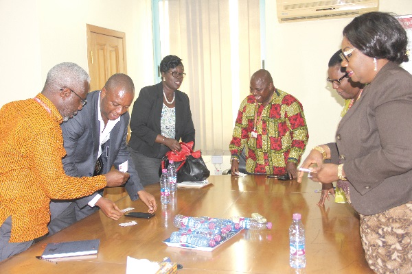 Chief Supt. Ms Owusua Kyeremeh (3rd left), Coordinating Director of DOVVSU, interacting with Mr Ransford Tetteh (3rd right) and some officials of GCGL at the meeting. Picture: EDNA ADU-SERWAA