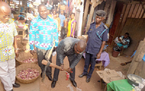 Mr Antwi-Boasiako (with pickaxe in hand) cutting the sod for the construction of the stores 