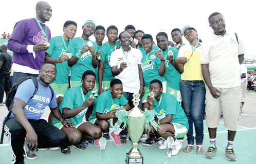 Officials and players of Kumasi Girls’ Senior High School display the medals and the trophy they were presented.