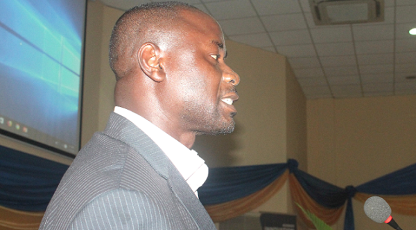 Dr Eric Osei-Assibey, Director of the School of Continuing and Distance Education, University of Ghana,  reading the communique