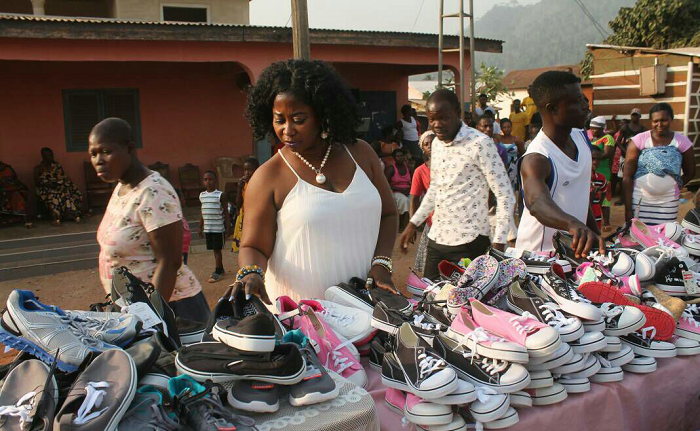 Jennifer Appiah (in white) arranging some of the shoes to be donated