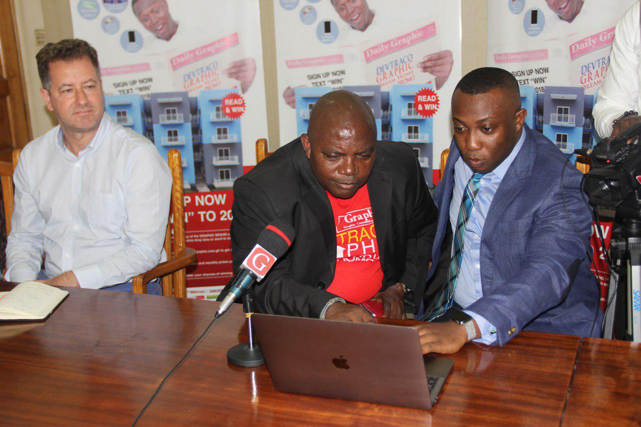 Mr Gideon Kyemanu Sarsah (right), Chief Operations Officer, Vokacom, taking Mr Ransford Tetteh (2nd left), acting Managing Director of the Graphic Communications Group Limited (GCGL), through the software used for the draw at the Graphic Head Office in Accra. With them is Mr Jorge Osorio, Group Sales and Marketing Director of Devtraco. Picture: EDNA ADU-SERWAA