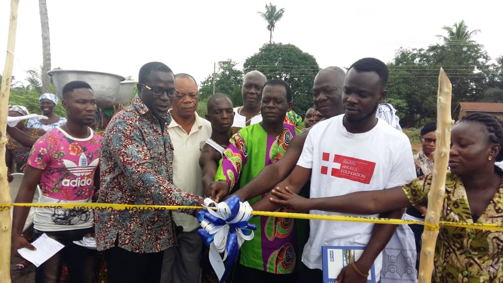 Co-founder of Swiss Angels, Mr. Francis Daffor, (right) inaugurating the water system with elders of the community