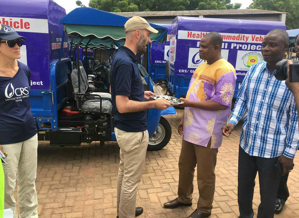 Mr Ozar (left) handing over the tricycles to Dr Abubakari, the Deputy Director, Clinical Care.