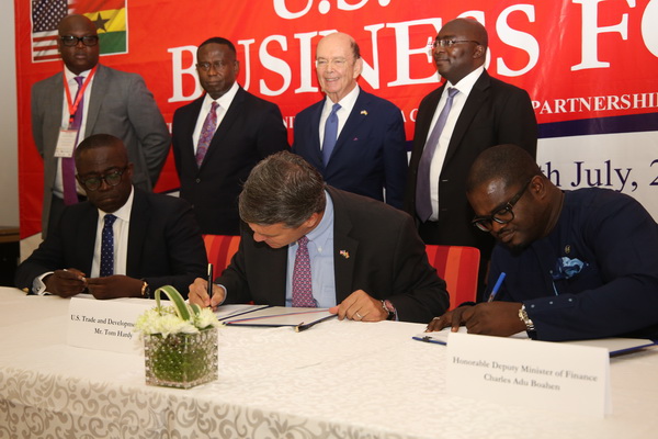 Mr Charles Adu Boahen (right) a deputy Minister of Finance and Mr Tom Hardy (2nd right), US Trade and Development Minister  signing the MOU . With them is Mr William Owuraku Aidoo (left), a deputy Minister of Energy. Behind them are Vice-President, Dr Mahamudu Bawumia (right) and Mr Wilbur Ross (2nd right), United States Secretary of Commerce
