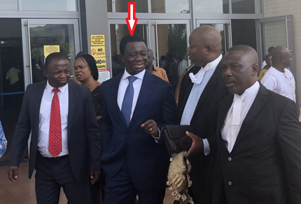 Dr Stephen Kwabena Opuni (arrowed) interacting with his lawyers