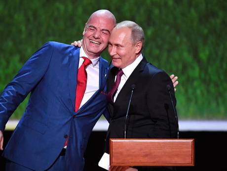 Russia's President Vladimir Putin embraces FIFA President Gianni Infantino as they address the audience during a gala concert at the Bolshoi Theatre on the eve of the soccer World Cup final match in Moscow