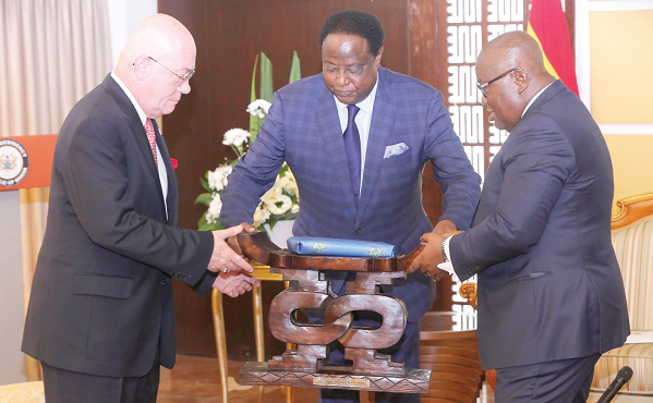 President Akufo-Addo presenting a gift to Mr Emmanuel Zeev Mahl (left), outgoing Israeli Ambassador to Ghana  (left). Picture: SAMUEL TEI ADANO