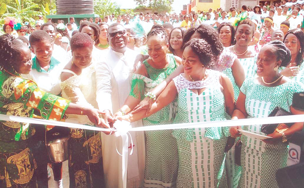 The Vicar General of the Catholic Archdiocese of Kumasi, Very Rev. Father Louis Tuffour (4th left), being assisted by the members of the 1993/95 year group to inaugurate the place of convenience.