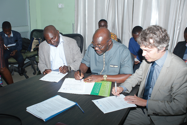 Mr Ebenezer Appiah-Sampong (middle), Deputy Executive Director of Technical Service of the Environmental Protection Agency, Mr Richard  Dacosta (left), Programme Officer of the Abidjan Convention, and  Mr Christian Nuemann (right), Programme Leader of Ecosystems and Sustainable Development of Grid Arendal, jointly signing the agreement at a ceremony in Accra.
