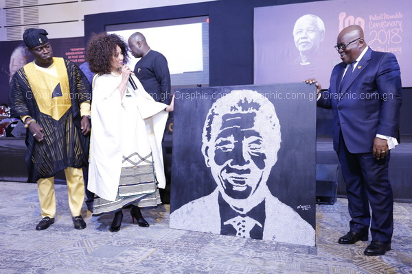 Dr Lindiwe Sigulu (left), the South African Minister for International Relations and Cooperation, presenting a portrait of Nelson Mandela to President Akufo-Addo at the centenary celebrations lecture in Accra. 