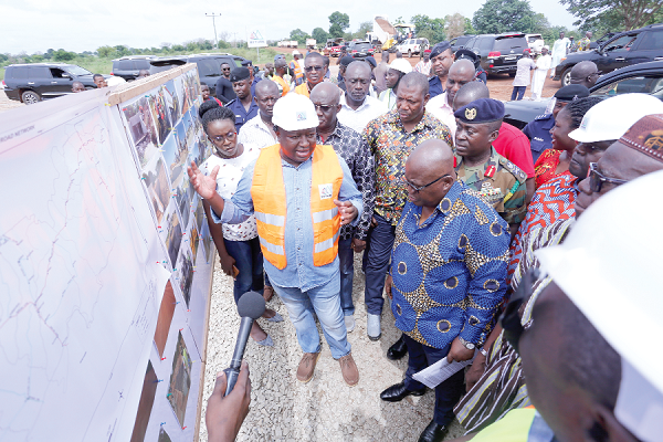 Mr Mytun Abdallah (in helmet), the contractor for the project, explaining the processes of the project to President Akufo-Addo at Builsa North. Picture: SAMUEL TEI ADANO