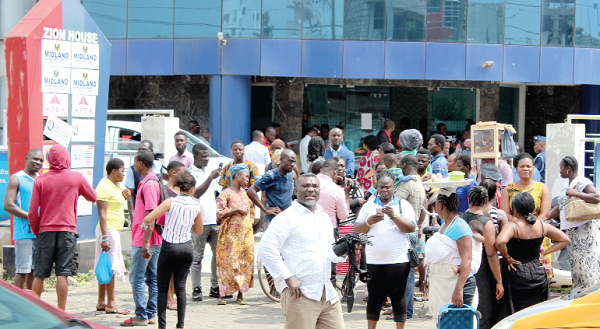 Some customers who thronged the premises of the Midland Savings and Loans Limited at Shiashie to withdraw their savings. Picture: INNOCENT K. OWUSU