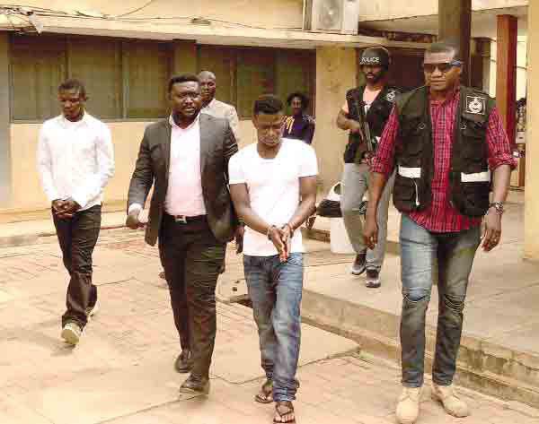 Daniel Asiedu (middle) and Vincent Bosso (left) being escorted from the court premises