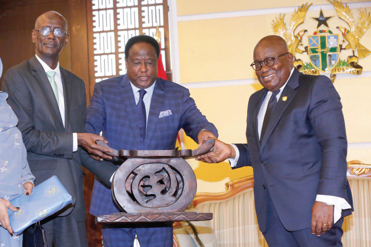 President Akufo-Addo presenting a gift to Mr Babikir Elsiddig Mohamed Elamin (left), out-going Sudanese Ambassador